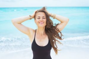woman at the beach with long hair, happy